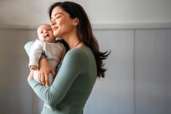 Loving mother carrying her newborn 600nw 2484587947.jpg