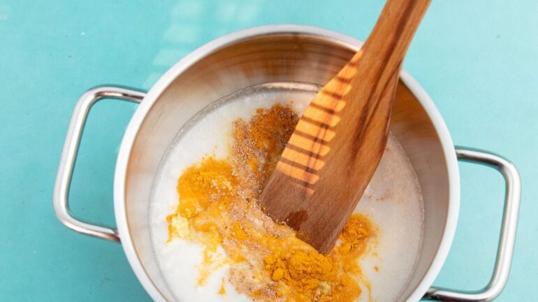 Turmeric latte mixed in pot